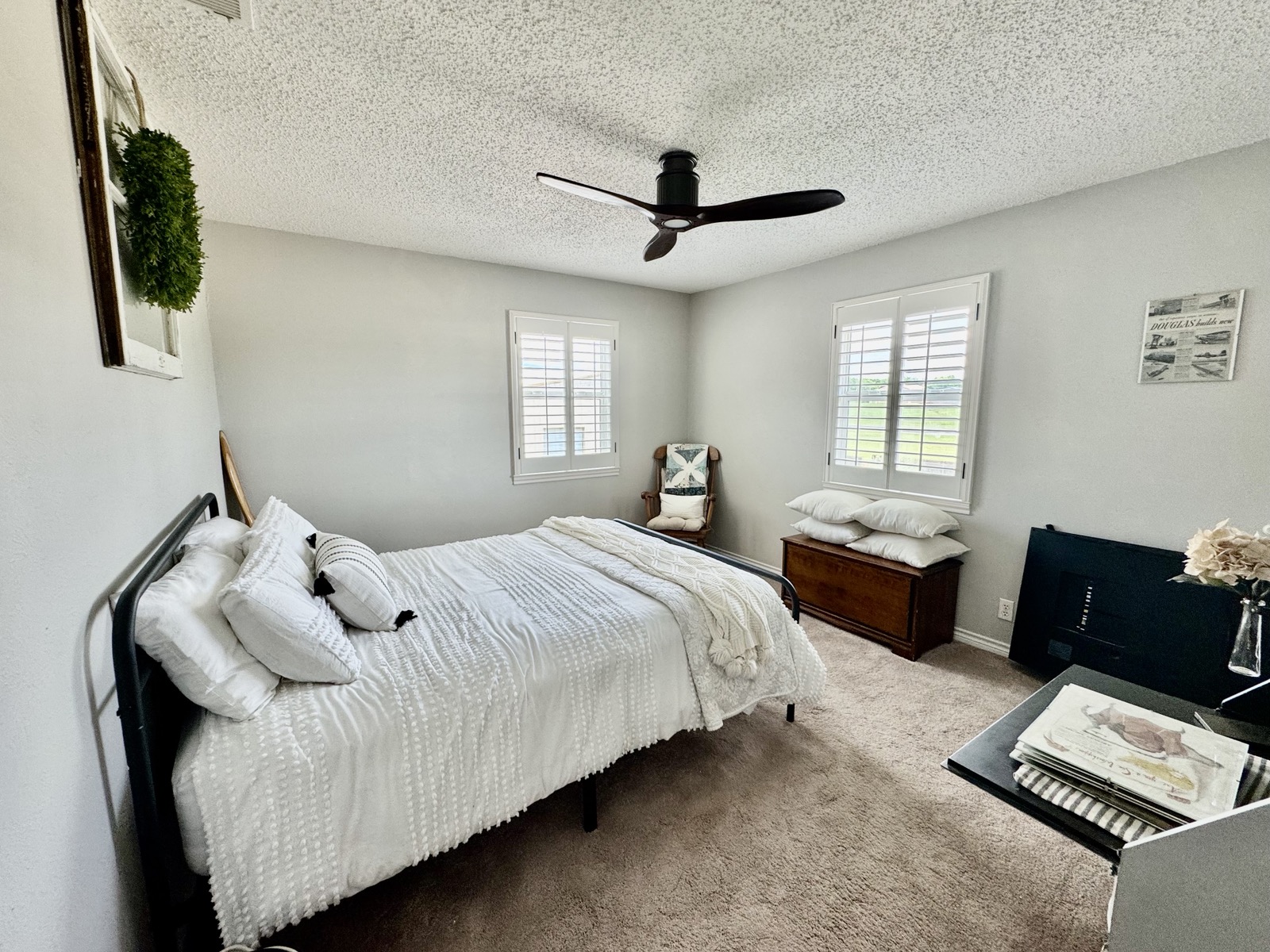 Guest bedroom with plantation shutters and natural light