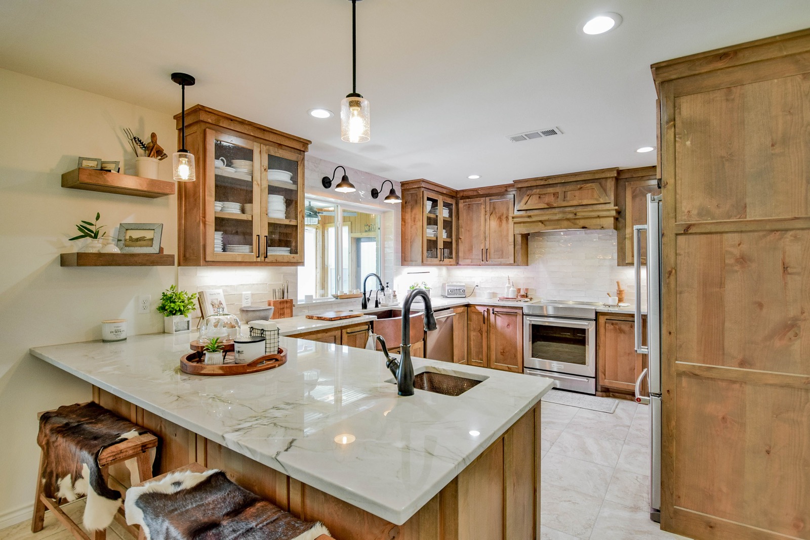 Kitchen viewed from island showing full layout, dual copper sinks, knotty alder