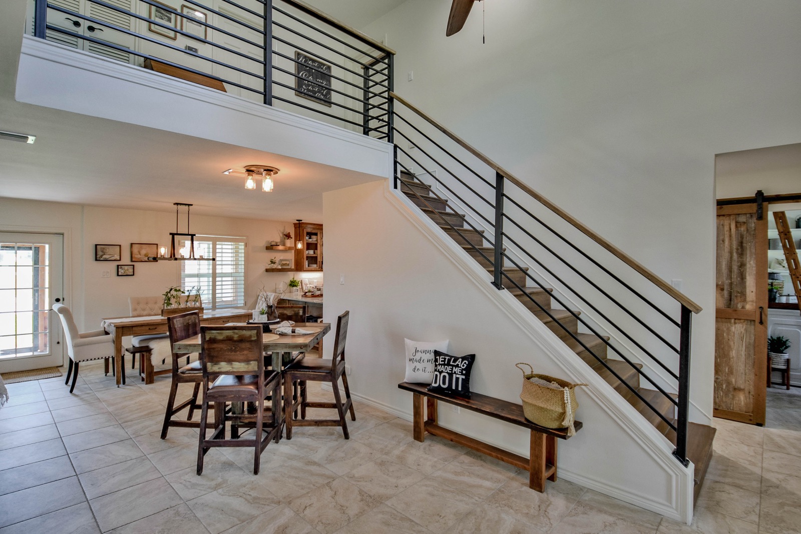 Rebuilt open stairway with steel-rail balusters and travertine floor